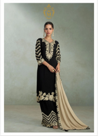 Maharani Royal Couture black chinon silk suit with heavy gold embroidery on neckline, sleeves, and hem. Paired with embroidered plazzo and dupatta.