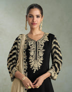 Maharani Royal Couture black chinon silk suit with heavy gold embroidery on neckline, sleeves, and dupatta. Beige dupatta draped.