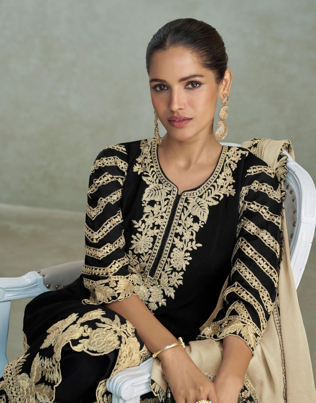 Maharani Royal Couture black chinon silk suit with heavy gold embroidery and handwork on kurta, plazzo, and dupatta.