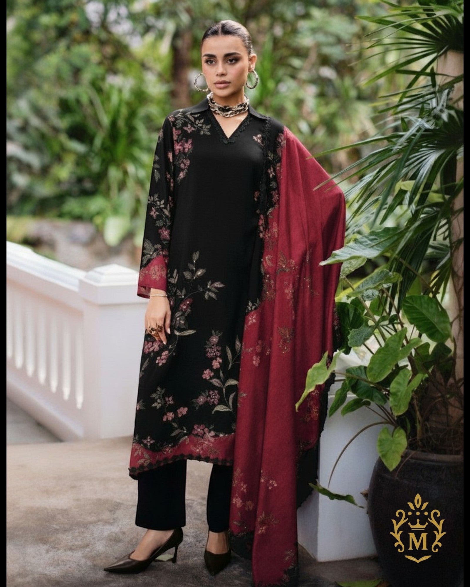 Maharani Royal Couture black viscose muslin suit with digital floral print, handwork, lace trim, and maroon dupatta. Model wears black pants and heels.