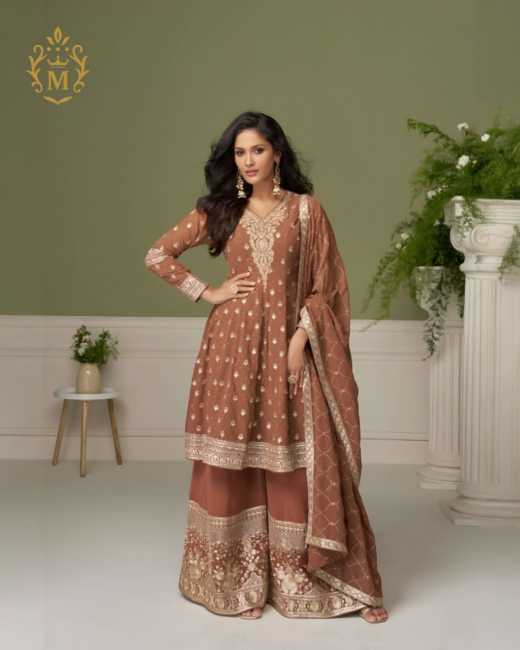 Maharani Royal Couture brown georgette suit with hand embroidery on neckline, sleeves, and hem, paired with heavily embroidered sharara pants and dupatta.