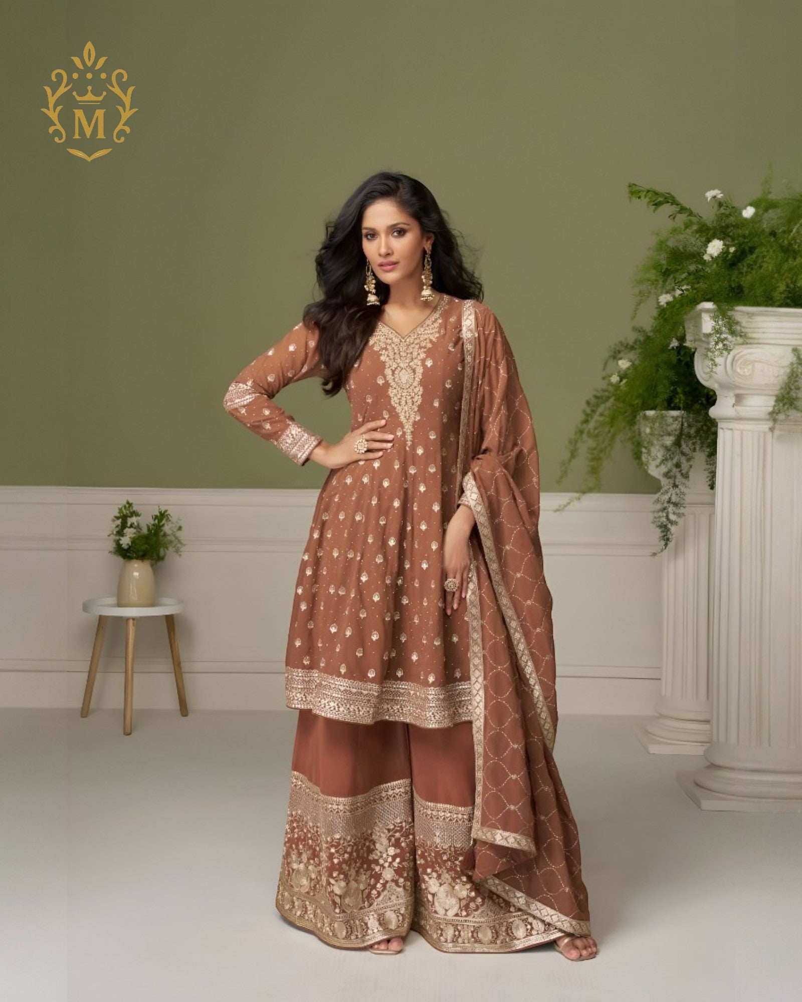 Maharani Royal Couture brown georgette suit with hand embroidery on neckline, sleeves, and hem, paired with heavily embroidered sharara pants and dupatta.
