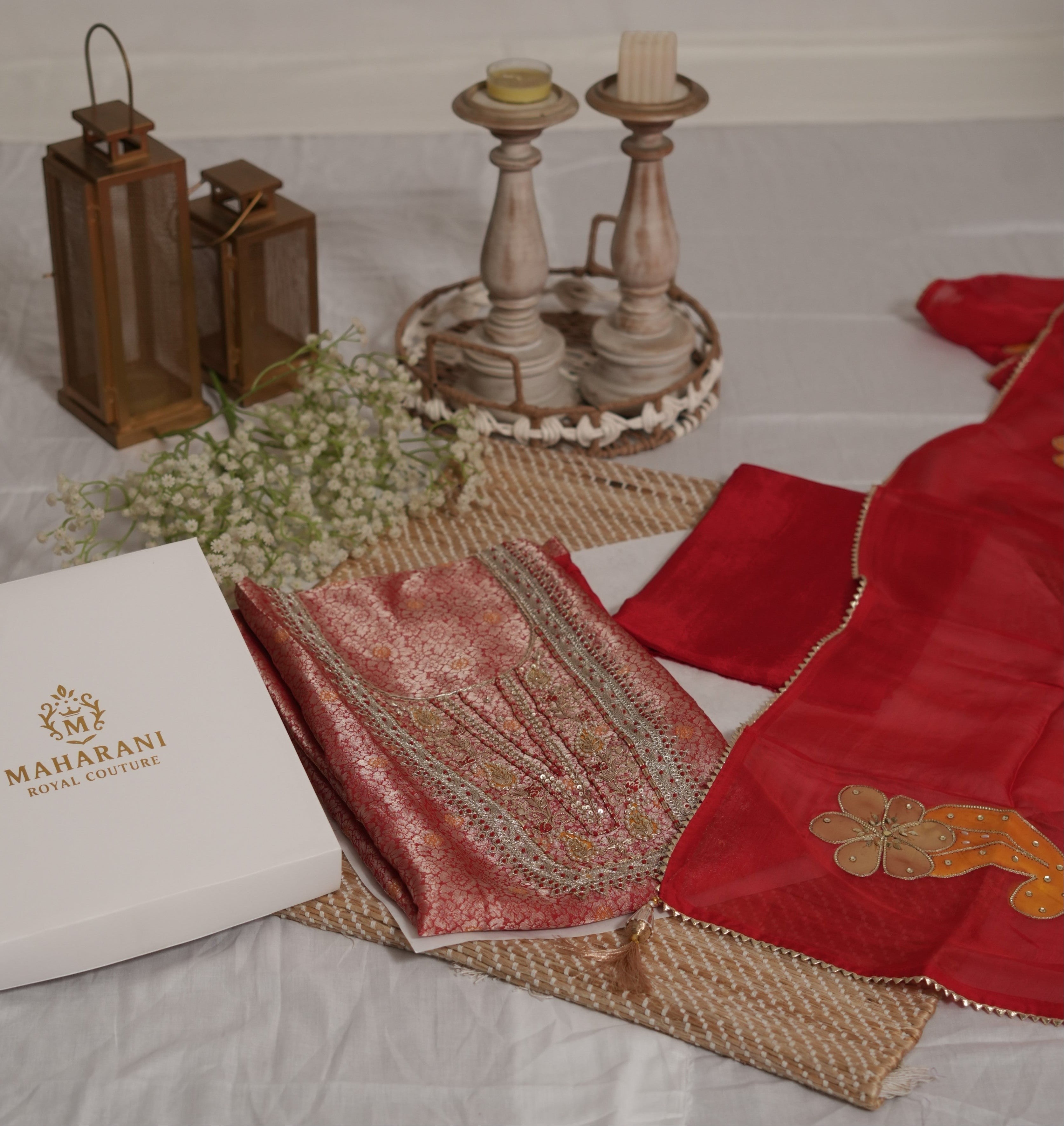 Maharani Royal Couture red Banarasi silk suit with intricate hand embroidery, sequins, pearls, and organza dupatta with painted motifs.