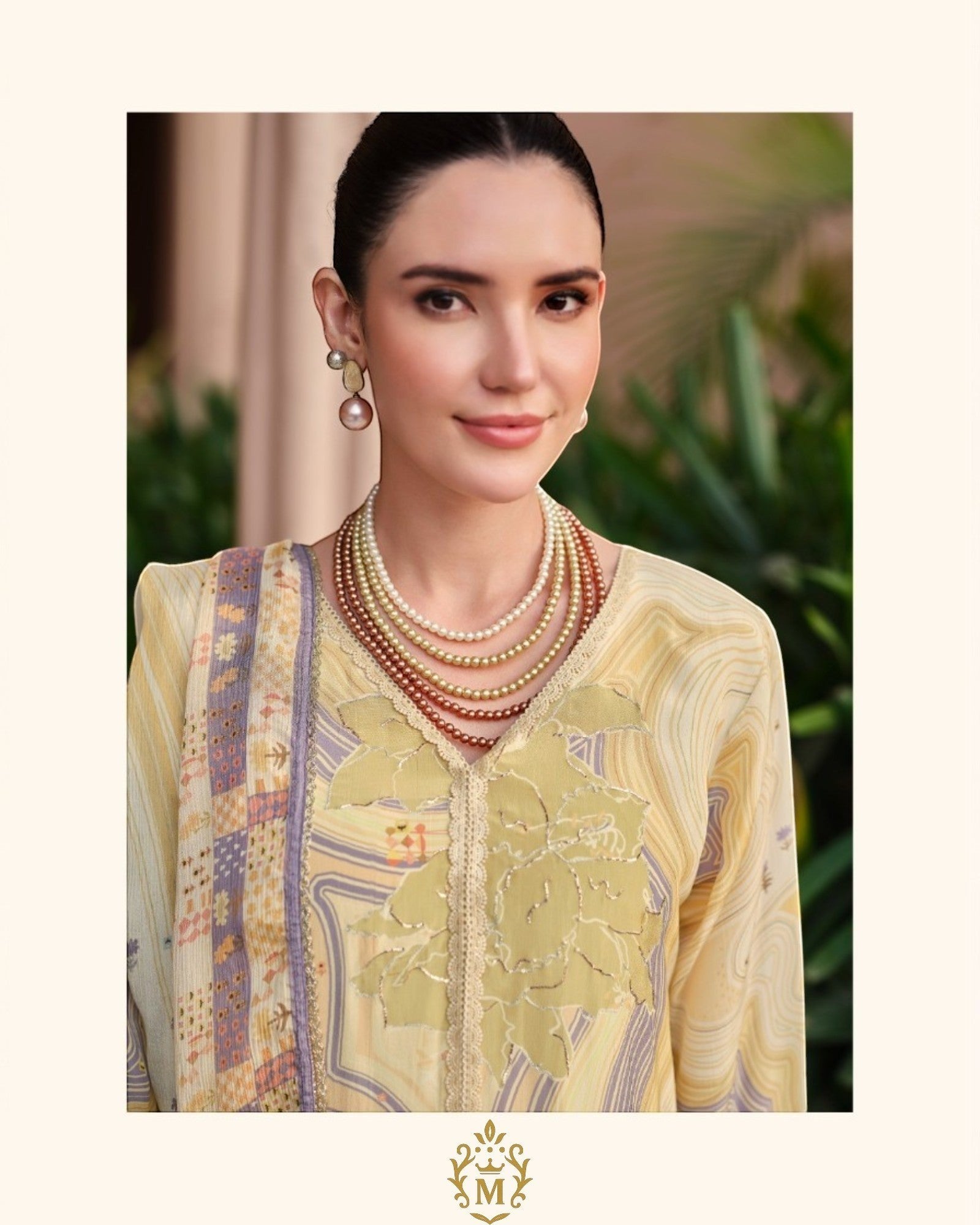 Maharani Royal Couture yellow mul cotton kurta with digital print, dabka work, and lace trim. Model wears pearl necklace.