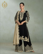 Maharani Royal Couture black chinon silk suit with heavy gold embroidery on kurta, plazzo pants, and dupatta.