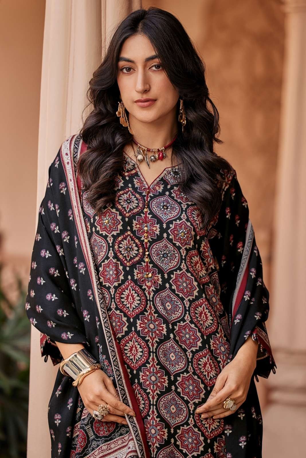 Maharani Royal Couture black viscose muslin suit with intricate digital print, mirror handwork, and tassels on dupatta.