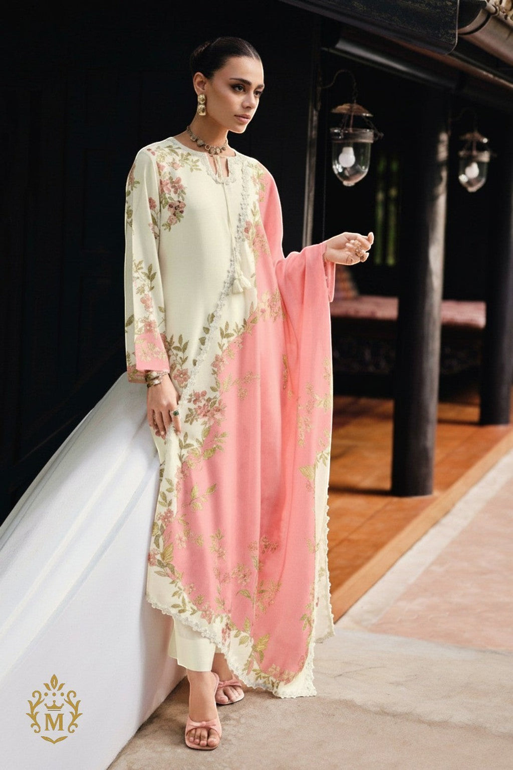 Maharani Royal Couture cream viscose muslin suit with digital floral print, handwork, lace trim, and pink dupatta. Model wears cream pants and pink heels.